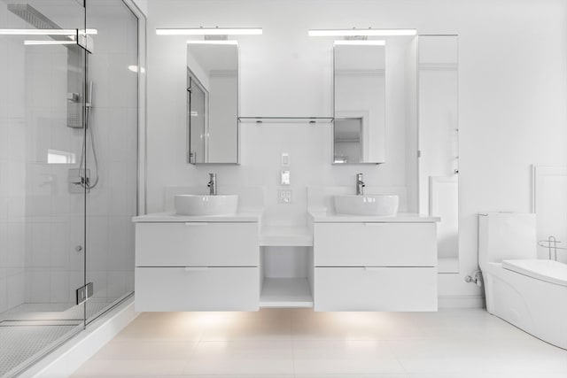 bathroom featuring tile patterned floors, vanity, toilet, and a shower with door