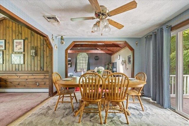 9 Oak Hill Rd, Mendon, MA 01756 - dining space with a baseboard heating unit, arched walkways, a textured ceiling, a ceiling fan, and wooden walls