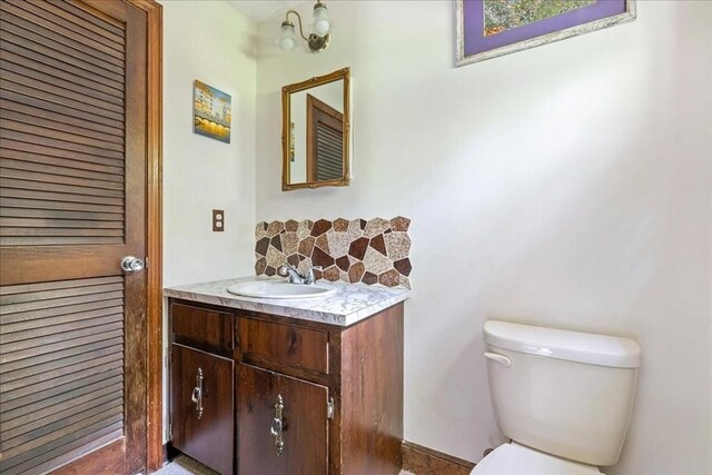 9 Oak Hill Rd, Mendon, MA 01756 - half bathroom with vanity, toilet, and backsplash