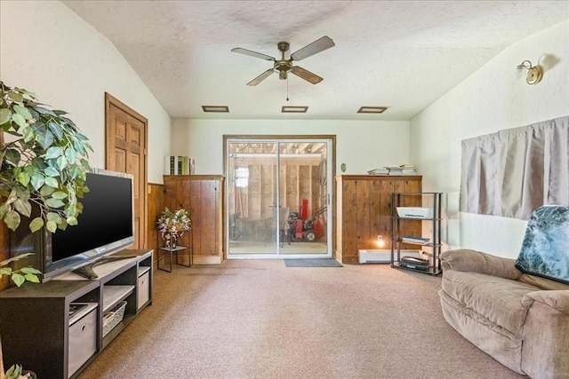 9 Oak Hill Rd, Mendon, MA 01756 - carpeted living area with a ceiling fan, a textured ceiling, a wainscoted wall, a baseboard radiator, and wood walls