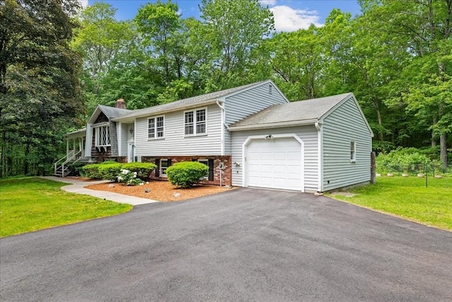 9 Oak Hill Rd, Mendon, MA 01756 - raised ranch with a garage, a chimney, a front yard, brick siding, and driveway