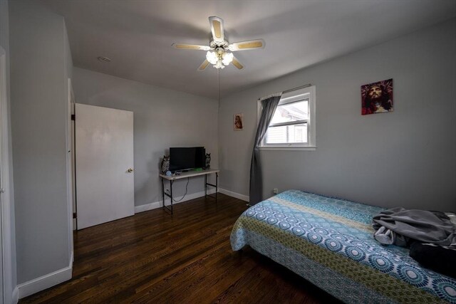 bedroom featuring ceiling fan, wood finished floors, and baseboards