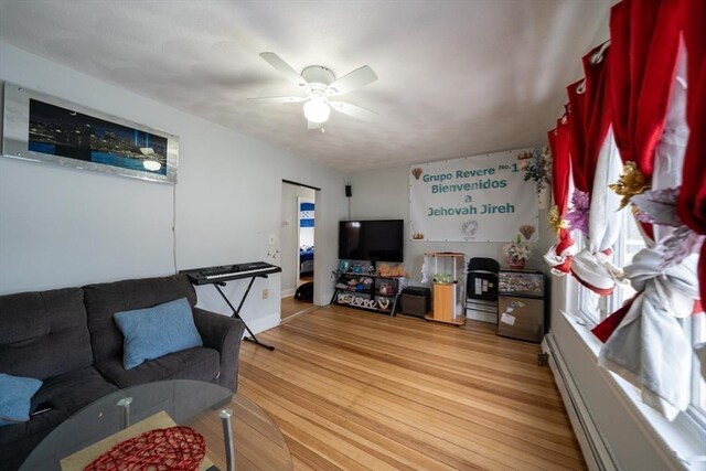 living room featuring ceiling fan and light wood-type flooring