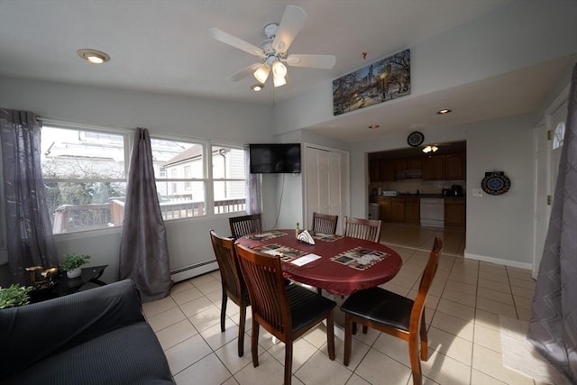 dining space with light tile patterned floors, ceiling fan, a baseboard radiator, and baseboards