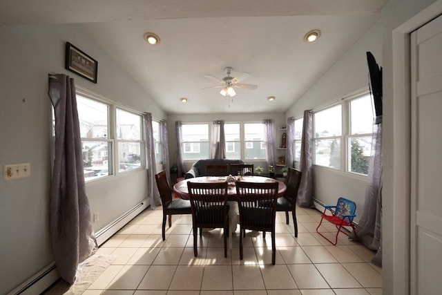 dining space featuring vaulted ceiling, light tile patterned floors, and a baseboard radiator