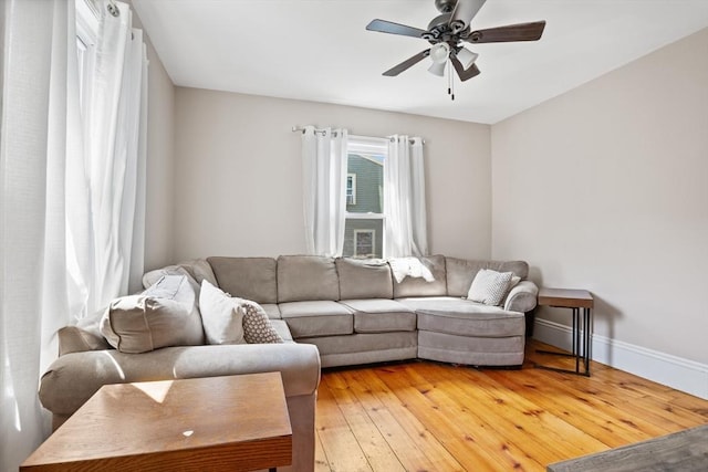 12 Russell St, Amesbury, MA 01913 - living area with ceiling fan and light wood-style floors