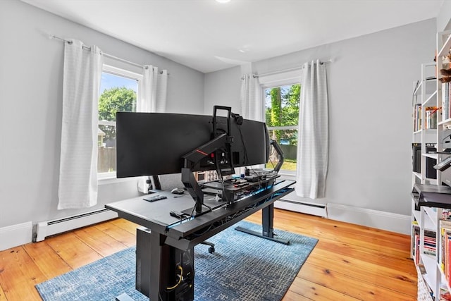 12 Russell St, Amesbury, MA 01913 - home office featuring a baseboard radiator, plenty of natural light, and hardwood / wood-style floors