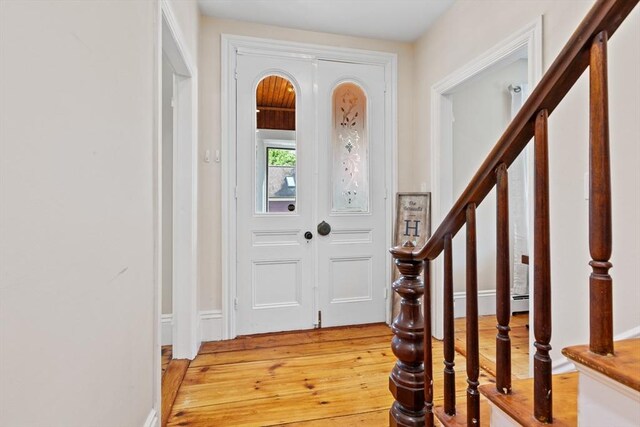 12 Russell St, Amesbury, MA 01913 - entrance foyer with light wood-style flooring and stairs