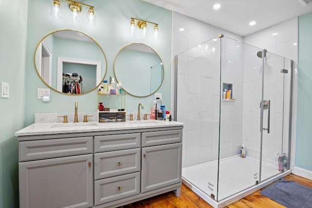 12 Russell St, Amesbury, MA 01913 - full bath featuring double vanity, a shower stall, wood finished floors, and recessed lighting