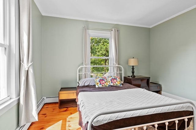 12 Russell St, Amesbury, MA 01913 - bedroom featuring crown molding, light wood-type flooring, and a baseboard radiator