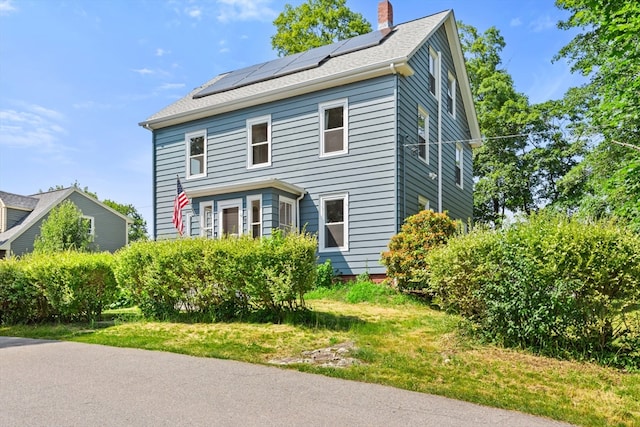 12 Russell St, Amesbury, MA 01913 - view of front of property featuring solar panels and a chimney