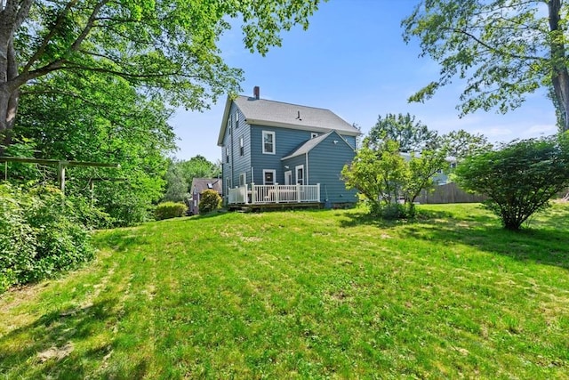 12 Russell St, Amesbury, MA 01913 - back of property featuring a wooden deck, a yard, and a chimney