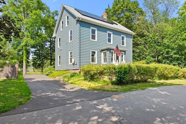 12 Russell St, Amesbury, MA 01913 - american foursquare style home featuring solar panels, a chimney, and driveway