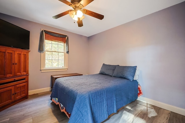 bedroom with light hardwood / wood-style floors and ceiling fan