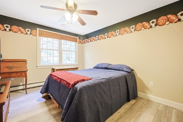 bedroom with ceiling fan, a baseboard heating unit, and light hardwood / wood-style floors