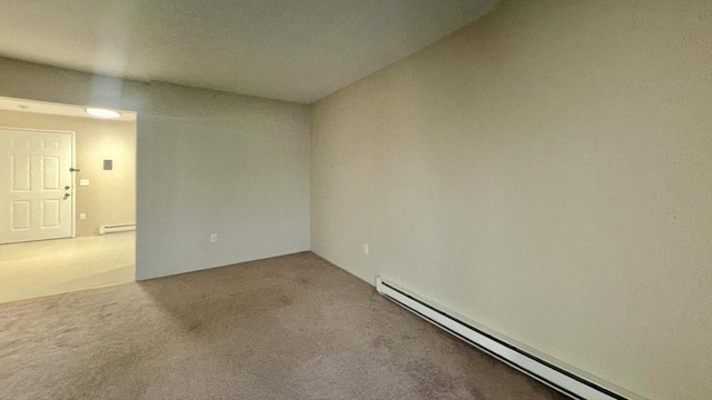 carpeted empty room with a baseboard heating unit and baseboard heating