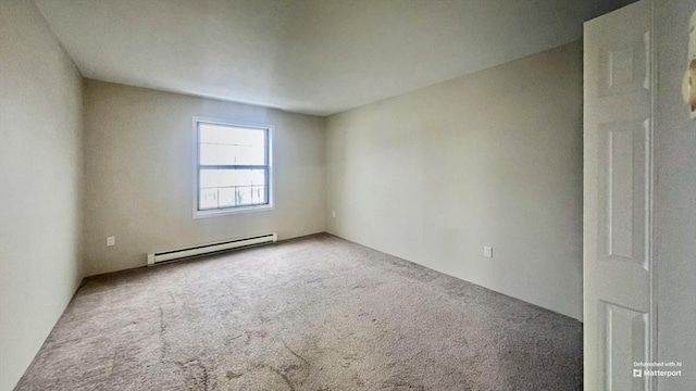 spare room with carpet and baseboard heating