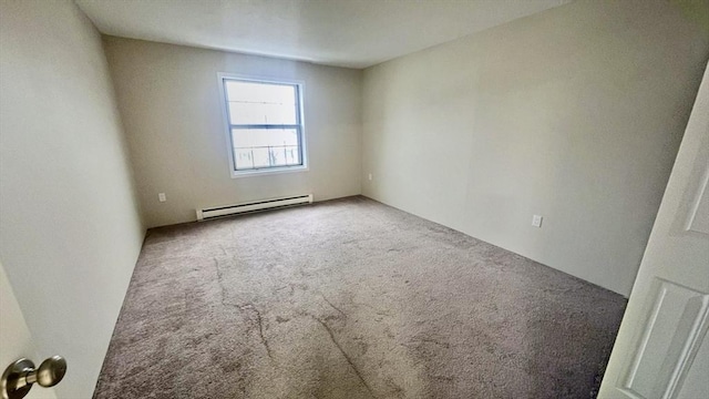 spare room with carpet flooring and a baseboard radiator