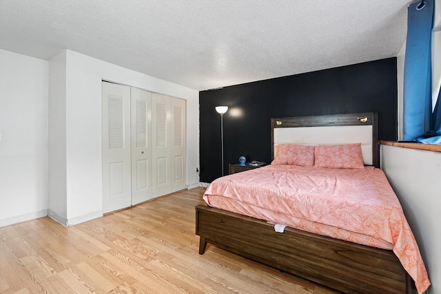 271 Humphrey St Unit H2, Lowell, MA 01850 - bedroom featuring wood finished floors, a closet, and a textured ceiling