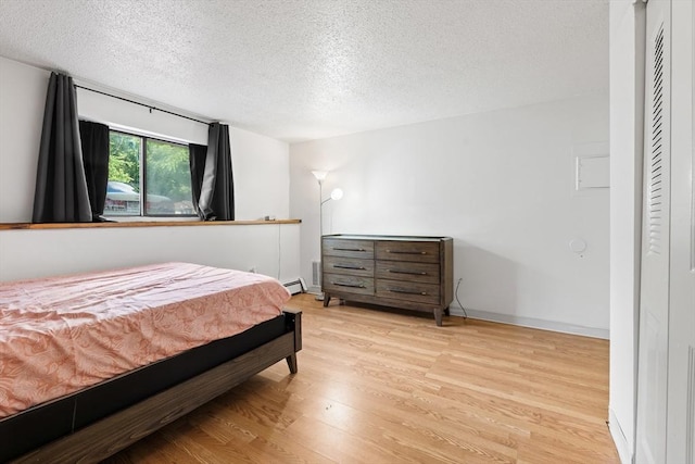 271 Humphrey St Unit H2, Lowell, MA 01850 - bedroom featuring a textured ceiling and wood finished floors
