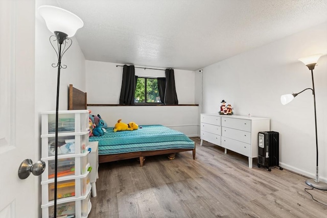 271 Humphrey St Unit H2, Lowell, MA 01850 - bedroom featuring wood finished floors and a textured ceiling