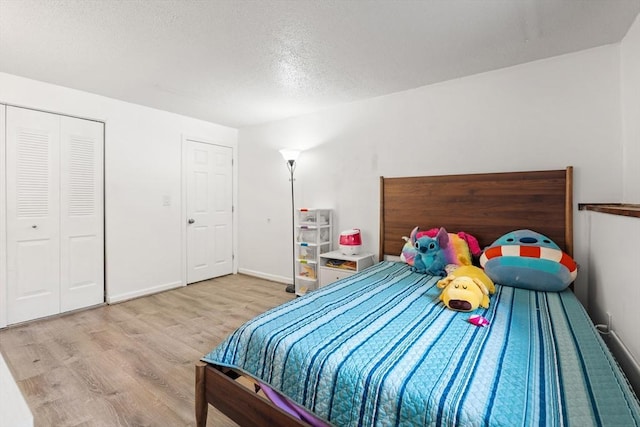 271 Humphrey St Unit H2, Lowell, MA 01850 - bedroom featuring wood finished floors and a textured ceiling