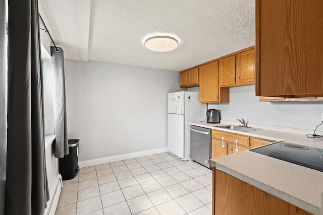271 Humphrey St Unit H2, Lowell, MA 01850 - kitchen with dishwasher, freestanding refrigerator, light countertops, a textured ceiling, and brown cabinetry