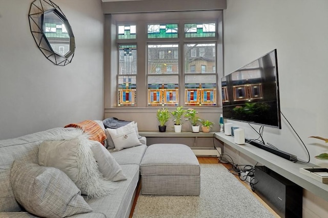 living area with baseboard heating and wood finished floors