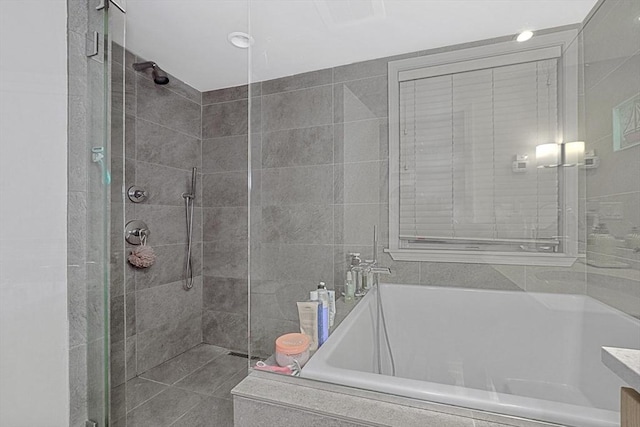 bathroom featuring a garden tub and a stall shower