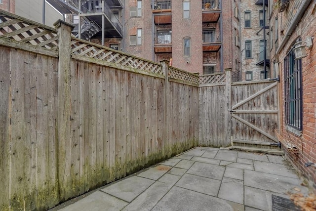 view of patio / terrace featuring fence and a gate