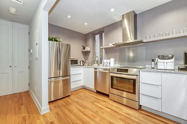 kitchen featuring open shelves, modern cabinets, wall chimney range hood, white cabinetry, and appliances with stainless steel finishes
