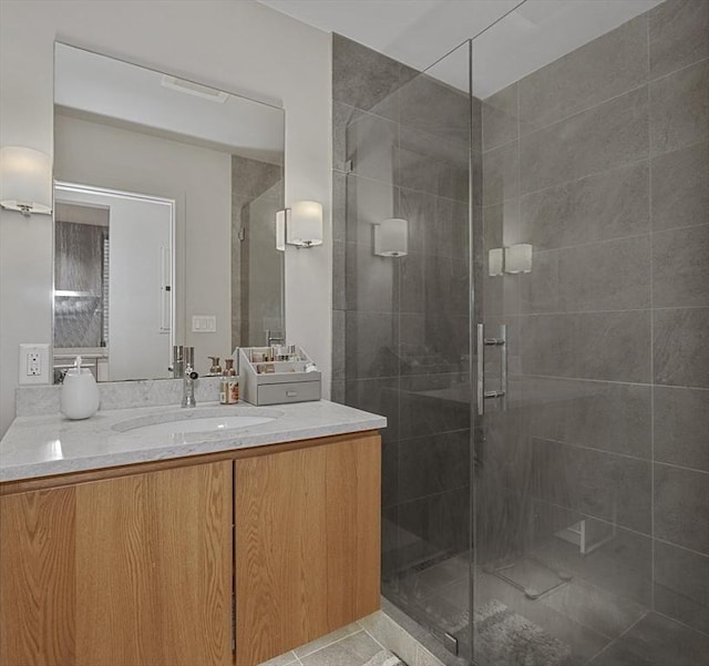 bathroom featuring vanity, tile patterned flooring, and a stall shower