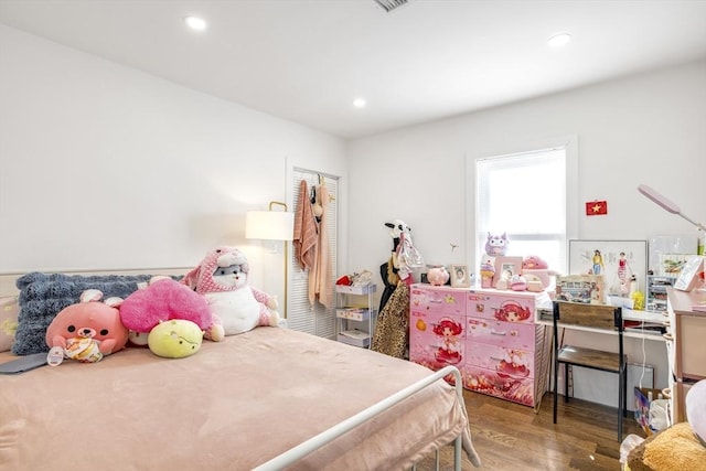 bedroom with wood finished floors and recessed lighting