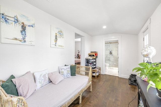 living room featuring lofted ceiling, dark wood-style flooring, and baseboards