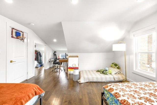 bedroom featuring vaulted ceiling, wood finished floors, and baseboards