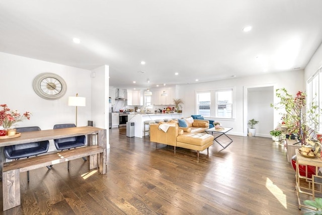 living room with dark wood-style floors, baseboards, and recessed lighting