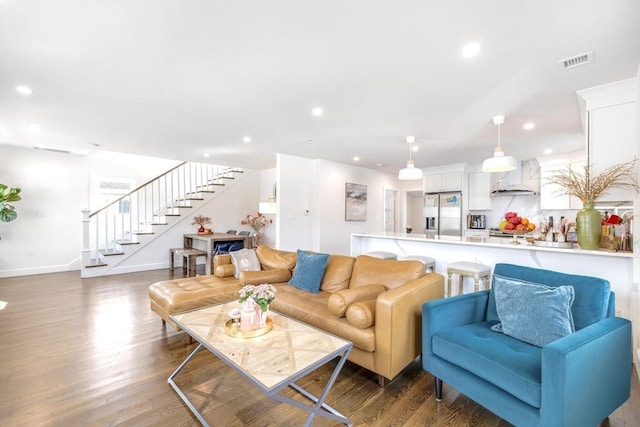 living room with stairs, visible vents, wood finished floors, and recessed lighting