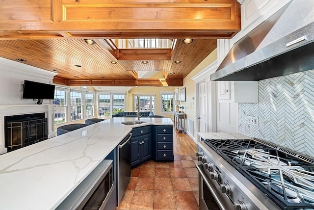 328 Central Ave, Scituate, MA 02050 - kitchen featuring wall chimney range hood, wood ceiling, blue cabinetry, open floor plan, and plenty of natural light