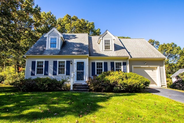 cape cod-style house featuring a front lawn and a garage