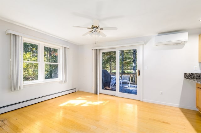 interior space with light hardwood / wood-style flooring, a wall mounted AC, and plenty of natural light