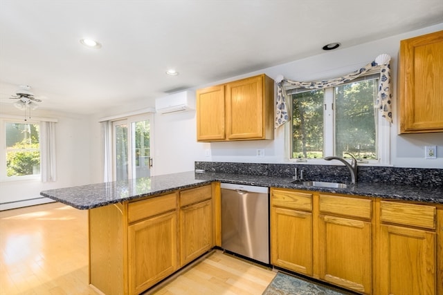 kitchen featuring dishwasher, light hardwood / wood-style flooring, kitchen peninsula, and dark stone counters