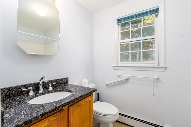 bathroom with vanity, toilet, and a baseboard radiator