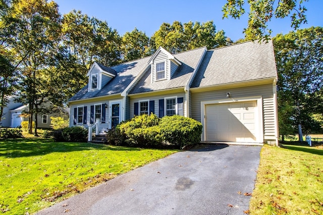 cape cod home featuring a garage and a front lawn