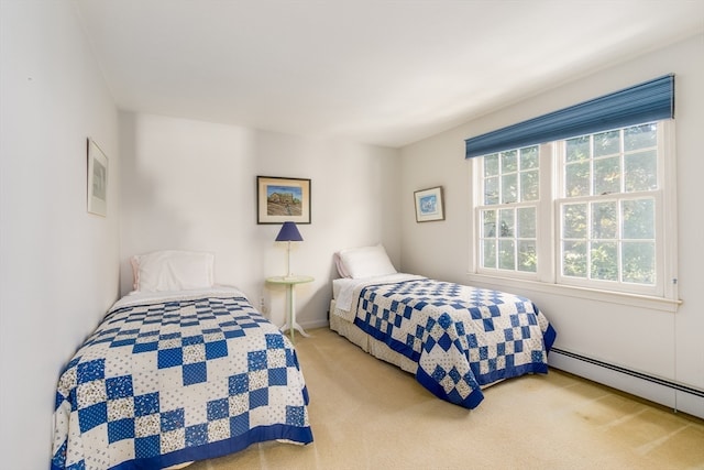 carpeted bedroom featuring a baseboard radiator