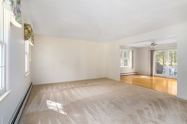 empty room featuring ceiling fan, light hardwood / wood-style flooring, and baseboard heating