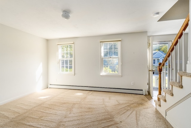 carpeted empty room with a baseboard heating unit