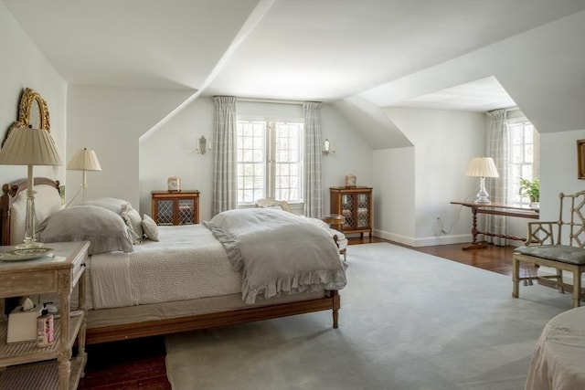 bedroom with lofted ceiling and dark wood-type flooring