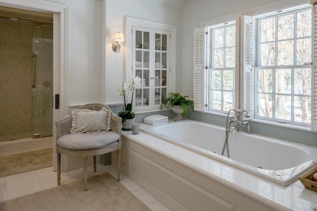 bathroom featuring plus walk in shower and tile patterned floors