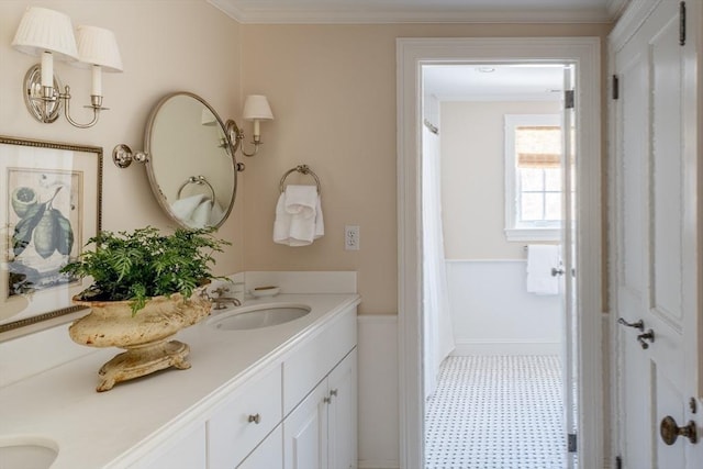 bathroom featuring ornamental molding and vanity