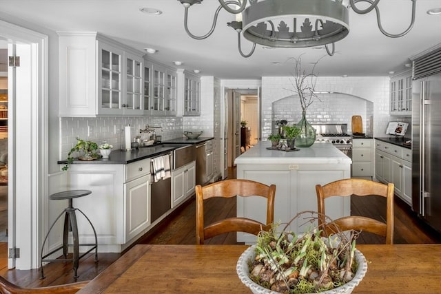 kitchen featuring white cabinetry, sink, decorative backsplash, and high quality appliances